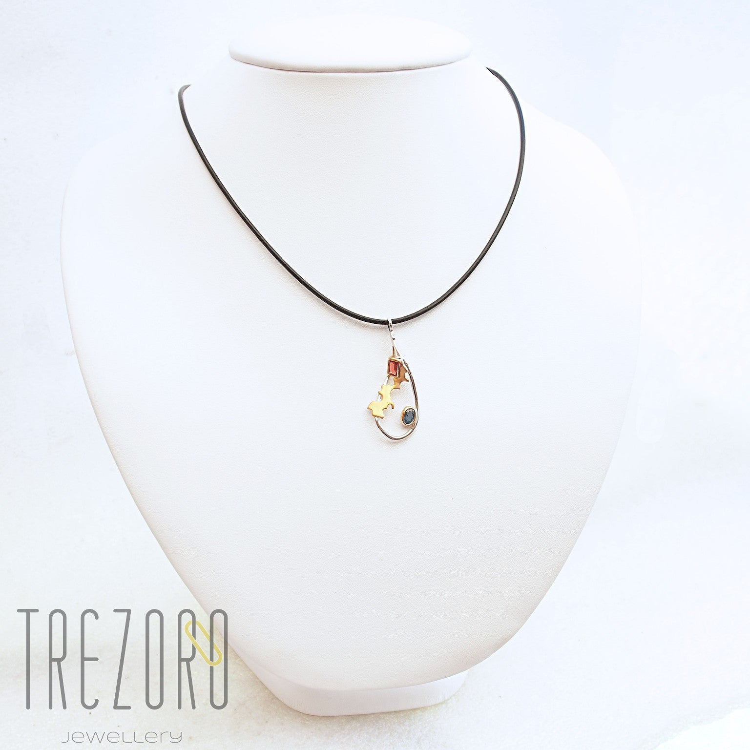 Adventure Road Designer Pendant. Sterling Silver with  Garnet and Sapphire, Rhodium and Gold Plated. On mannequin.